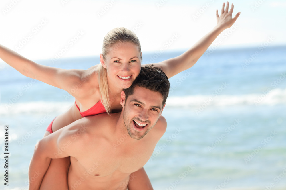Beautiful man having girlfriend a piggyback Beautiful man having girlfriend a piggyback