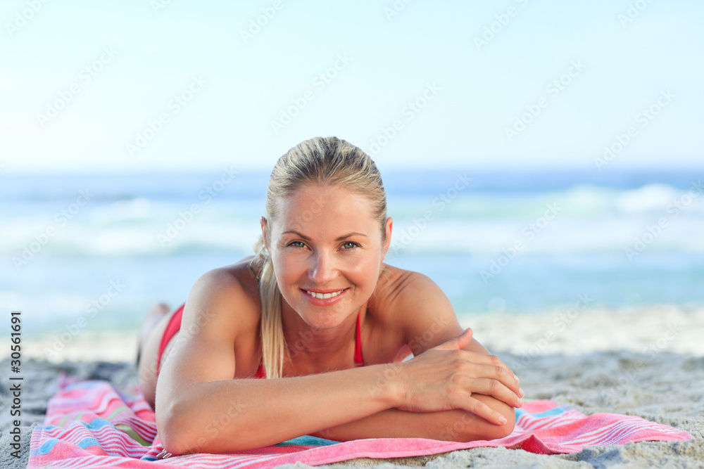 Beautiful woman lying down on the beach Beautiful woman lying down on the beach