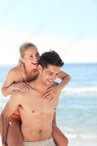 Beautiful man having girlfriend a piggyback © WavebreakMediaMicro