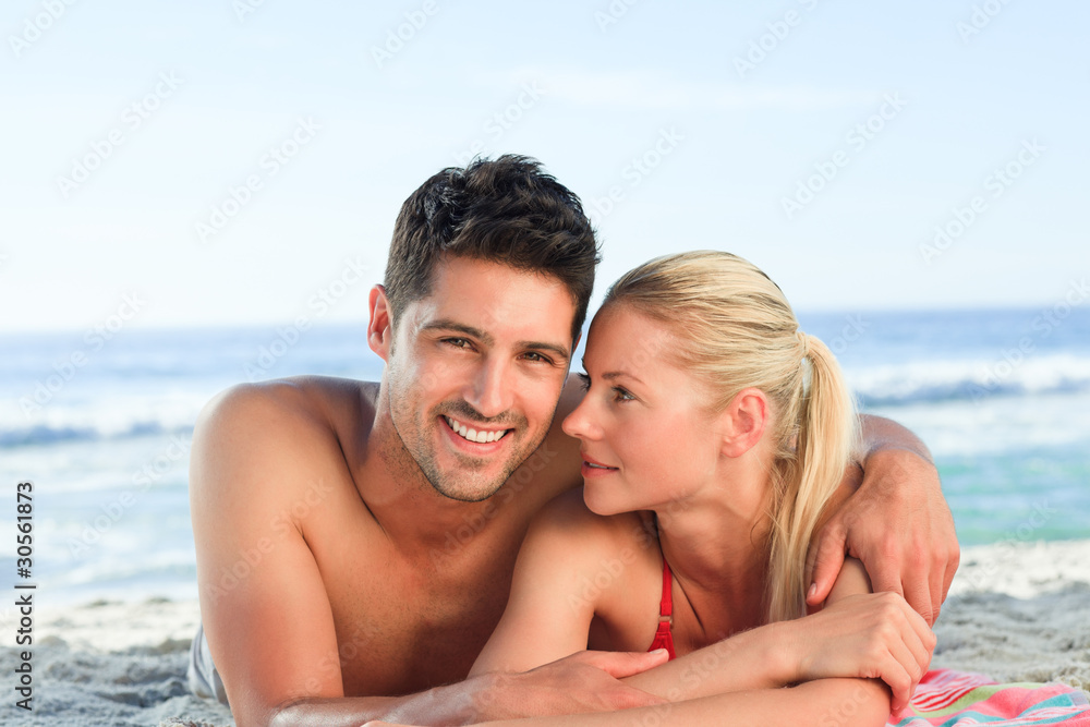 Lovers lying down on the beach