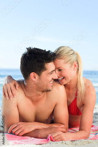 Lovers lying down on the beach
