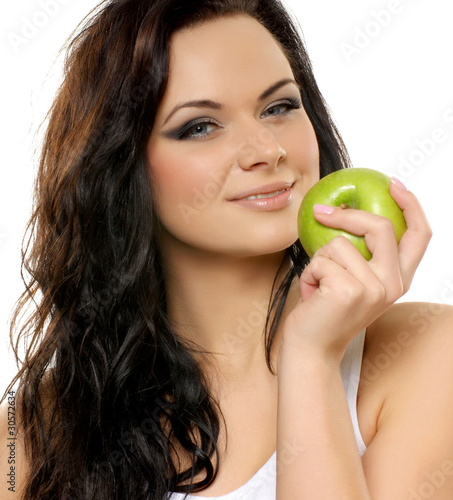 Portrait of a young and attractive woman with a green apple
