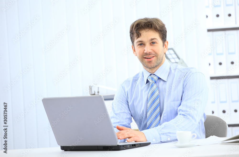 Closeup of employee in the office working on laptop computer Closeup of employee in the office working on laptop computer
