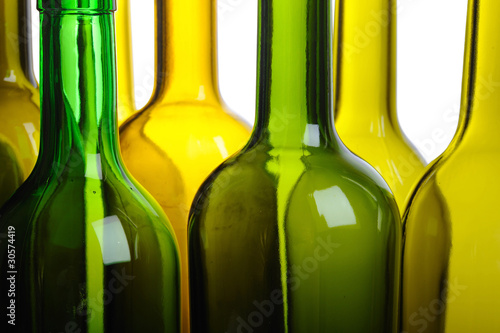 Many empty green wine bottles isolated on white background