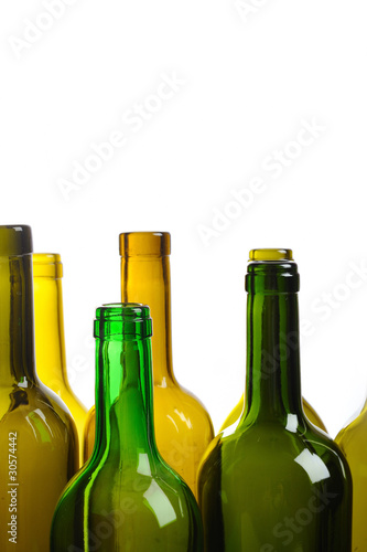 Many empty green wine bottles isolated on white background