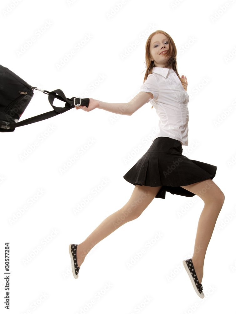 Fototapeta premium The red girl in a black skirt runs on a white background