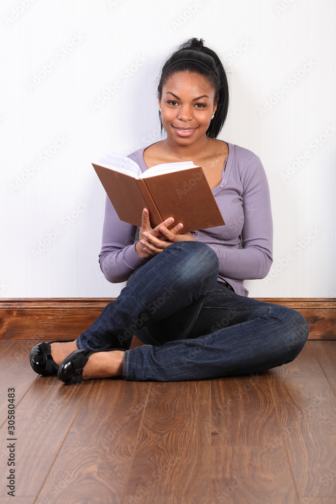 Beautiful african american girl reading a book Beautiful african american girl reading a book