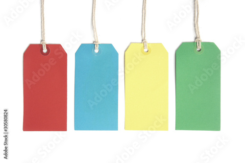 Four price or luggage tags coloured red, blue, yellow and green