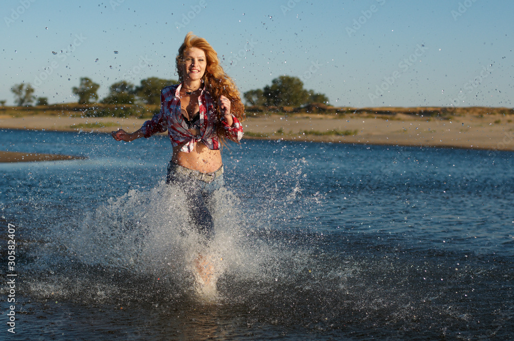 Fototapeta premium The red girl on a beach