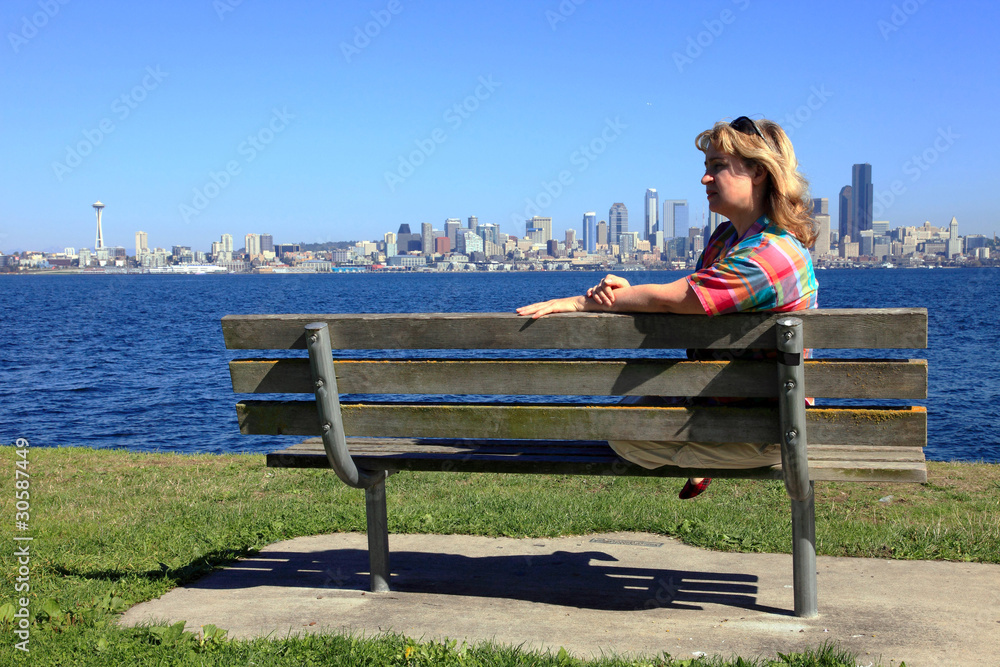 Sitting on a bench with a view of Seattle skyline.