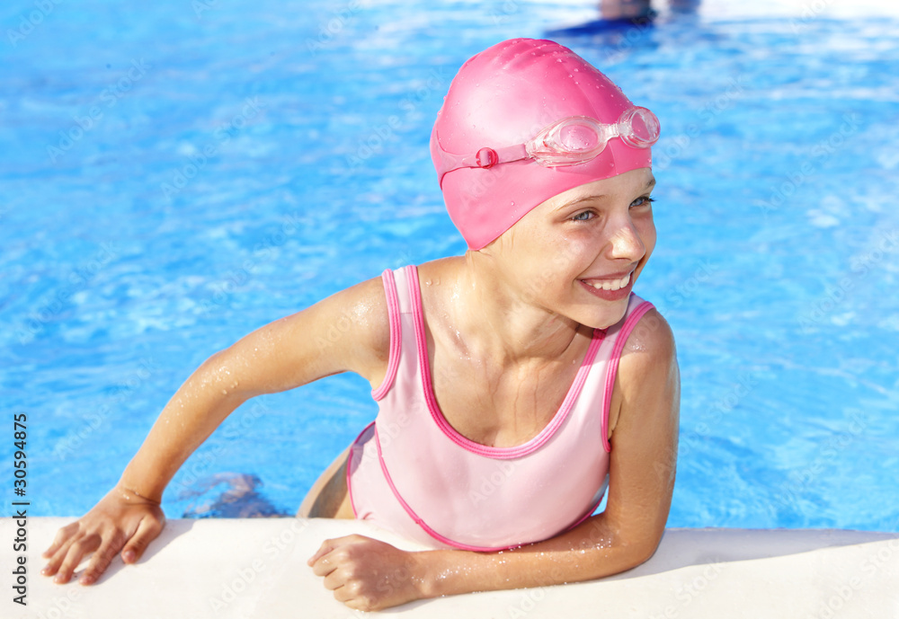 Child swimming in pool.