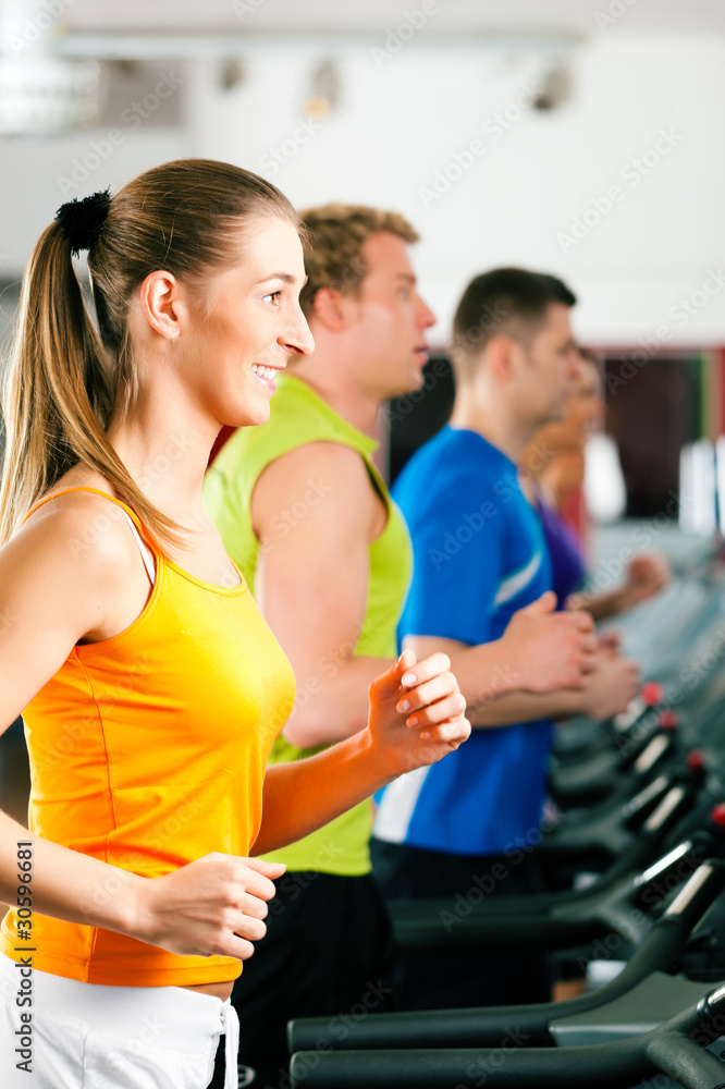 People in gym on treadmill running People in gym on treadmill running