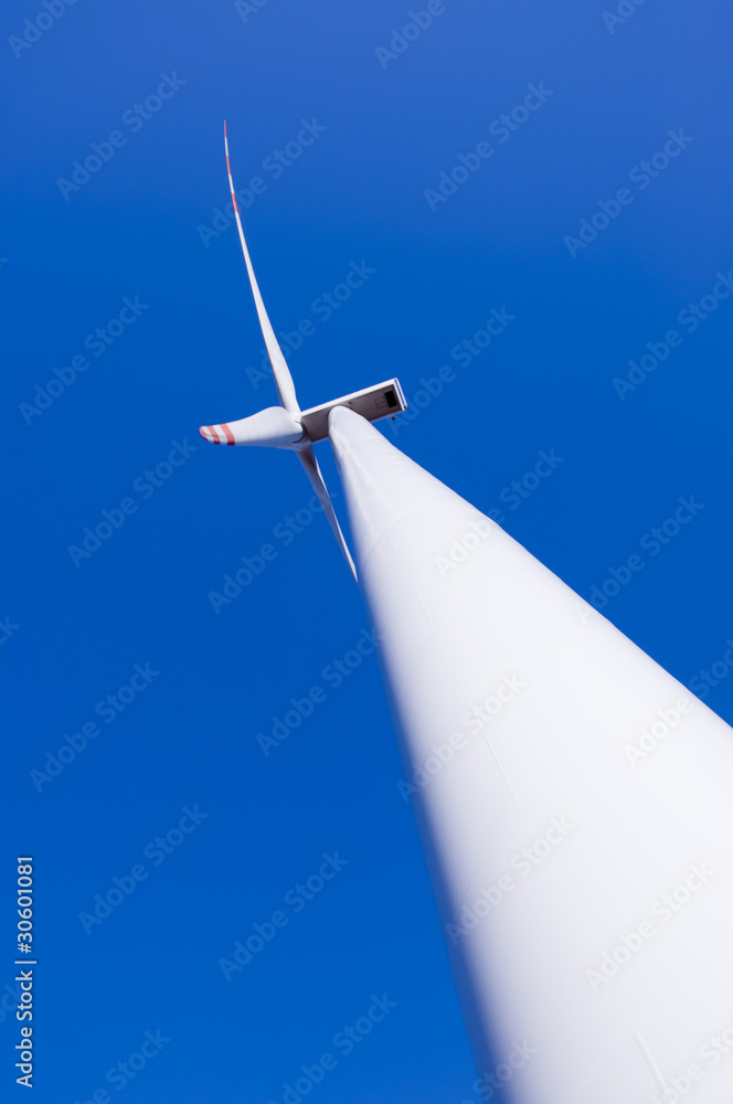 Wind turbine against blue sky