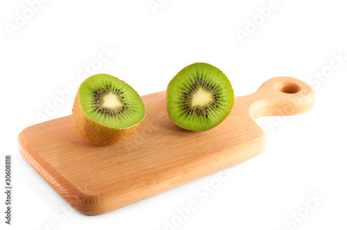 halves of kiwi on the cutting board isolated over white