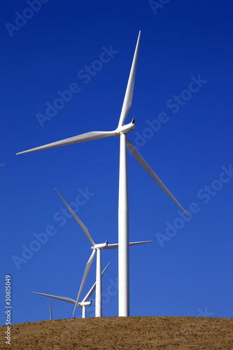 Wind-powered generator against the blue sky