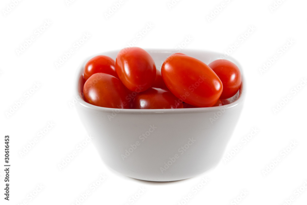 A bowl of red cherry tomatoes on an isolated background A bowl of red cherry tomatoes on an isolated background