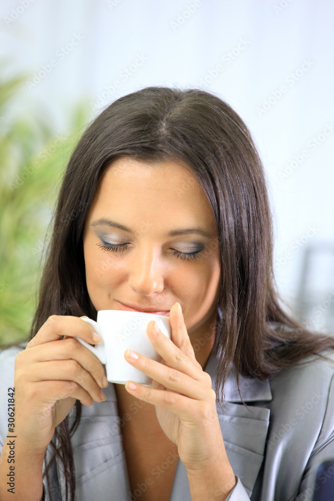 Portrait of relaxed businesswoman holding a cup of Portrait of relaxed businesswoman holding a cup of