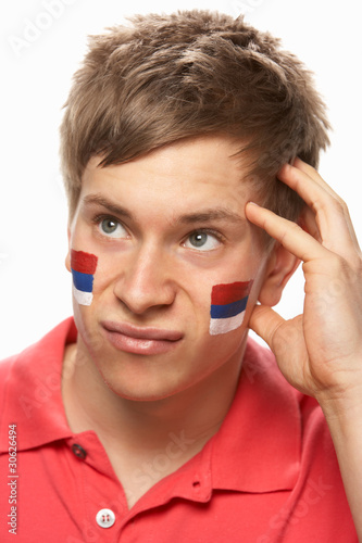 Disappointed Young Male Sports Fan With Serbian Flag Painted On photo