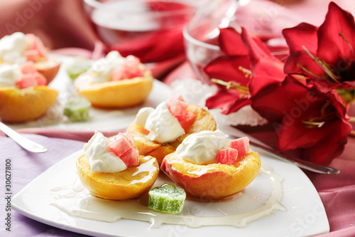 peaches baked and decorated with cream