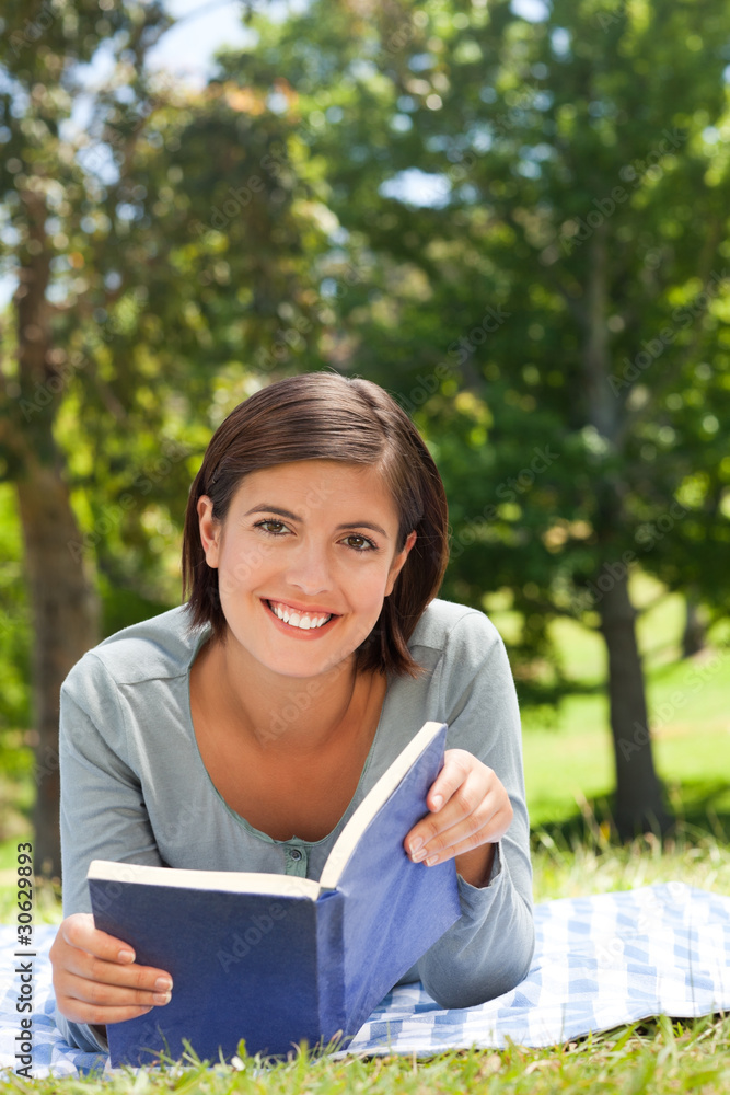 Woman reading a book in the park Woman reading a book in the park