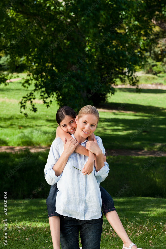 Mother having daughter a piggyback Mother having daughter a piggyback