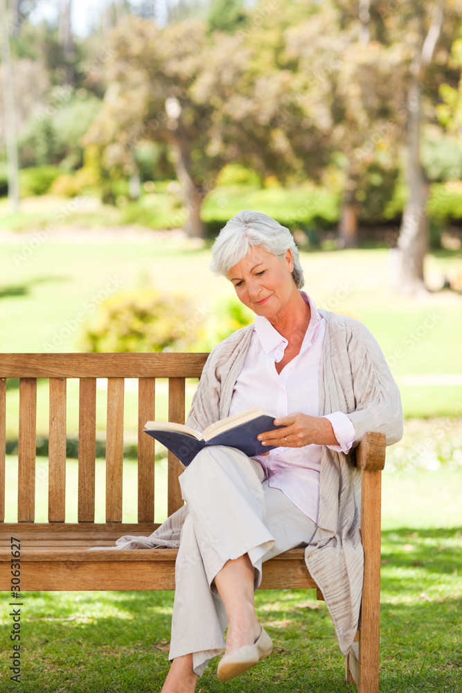 Fototapeta premium Retired woman reading a book