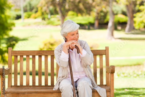 Photos Woman with her walking stick in the park