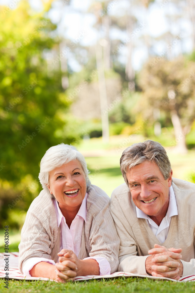 Mature couple lying down in the park Mature couple lying down in the park