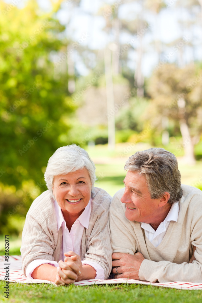 Mature couple lying down in the park Mature couple lying down in the park