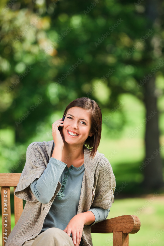 Beautiful woman phoning on the bench Beautiful woman phoning on the bench