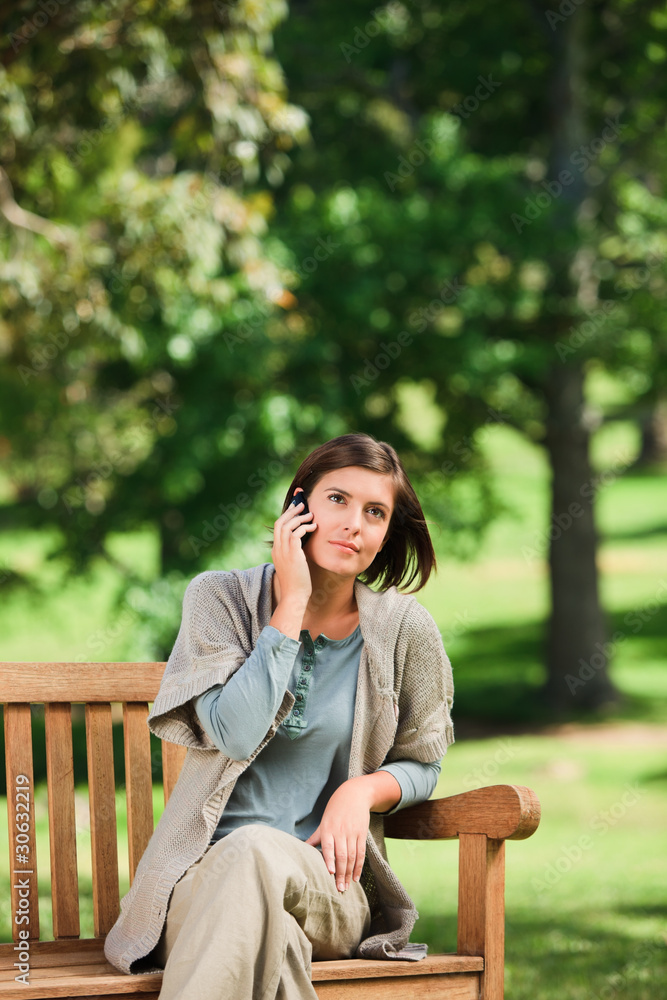 Woman phoning on the bench Woman phoning on the bench