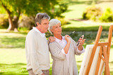 Retired couple painting in the park