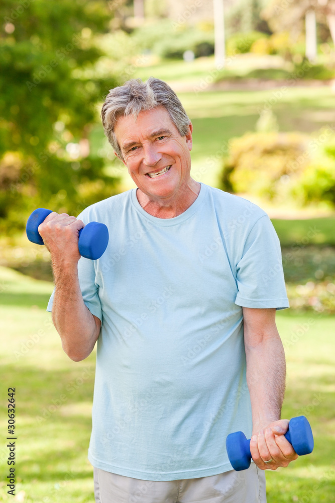 Mature man doing his exercises in the park Mature man doing his exercises in the park
