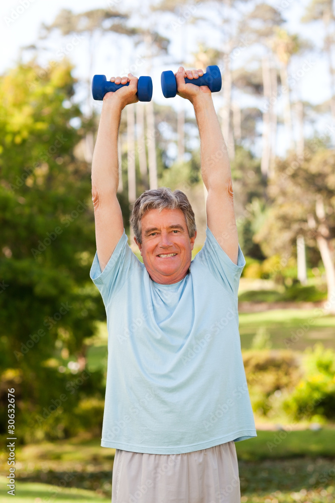 Mature man doing his exercises in the park