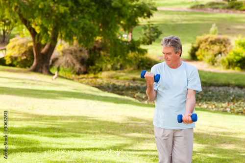 Elderly man doing his exercises in the park