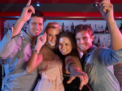 Group Of Young People Having Fun In Busy Bar