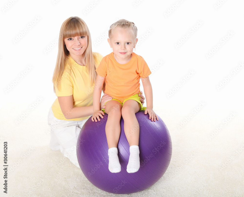 mother and little daughter doing sport together mother and little daughter doing sport together