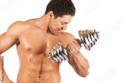 Strong muscullar man holding chromed dumbbell photo