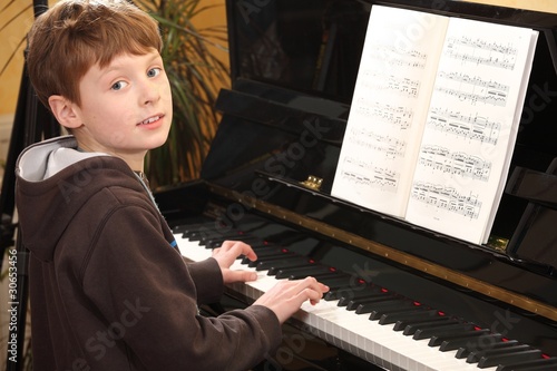 Netter Junge spielt Klavier photo
