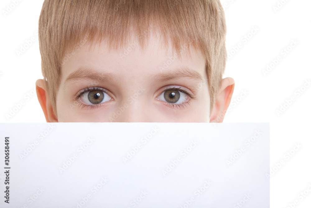Boy hiding over sheet of paper Boy hiding over sheet of paper