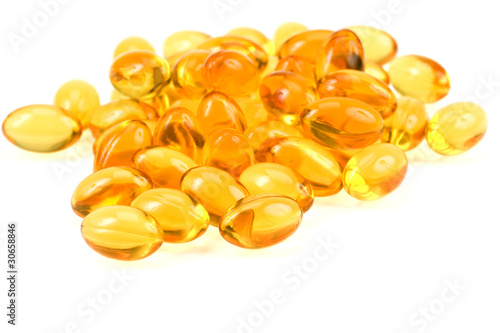 Transparent gold fish oil pills close-up
