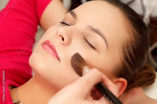 Woman with makeup brush