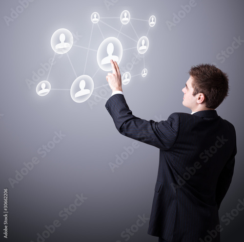 business man pressing a digital social network icon.