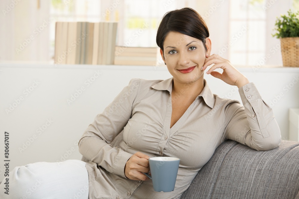 Portrait of young woman drinking coffee Portrait of young woman drinking coffee