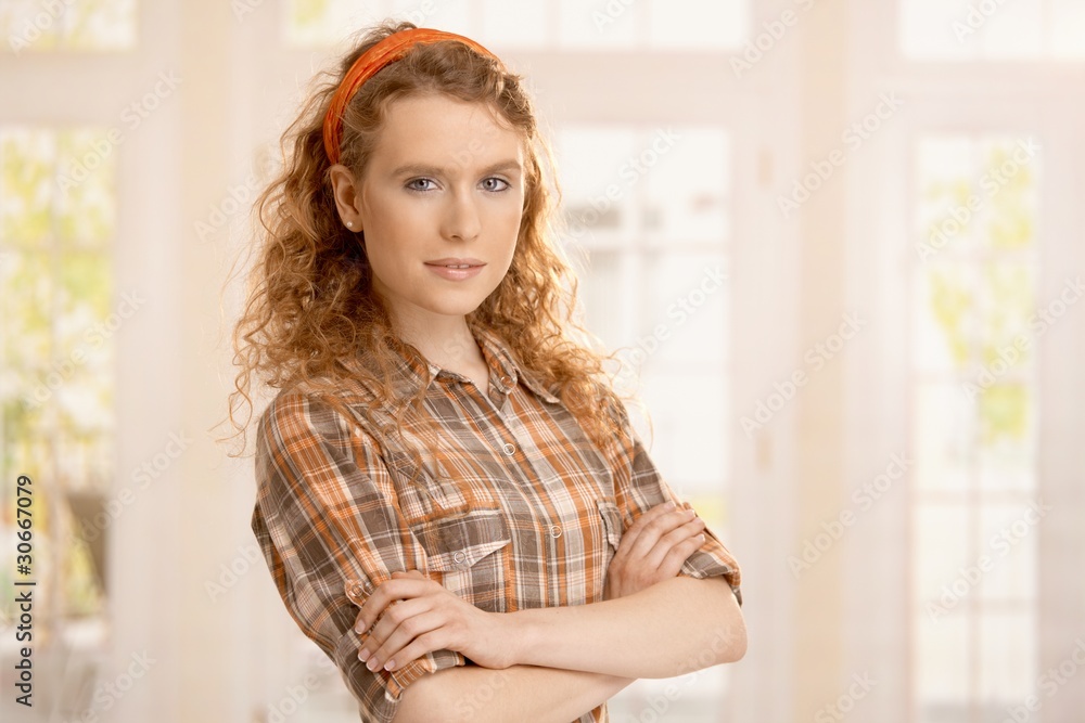 Portrait of pretty young girl at home smiling
