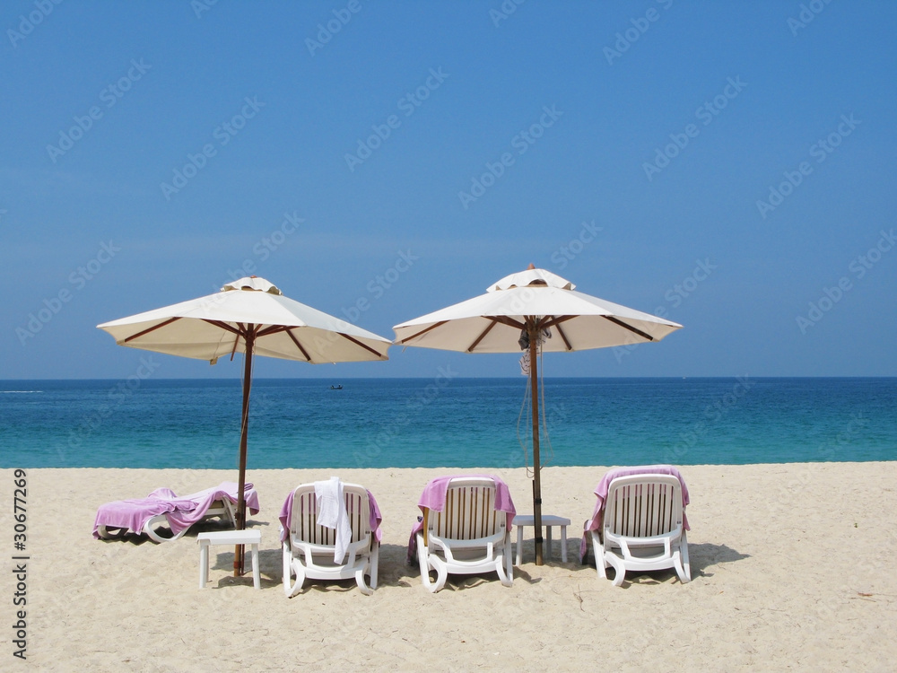 Sun umbrellas and chairs on the Bang Tao beach of Phuket island