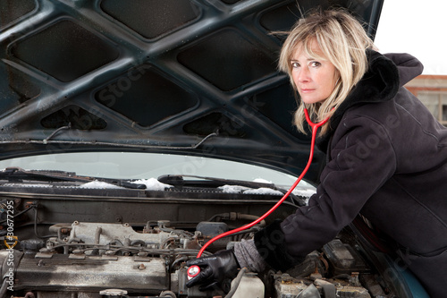 Woman figuring out what`s wrong with her car