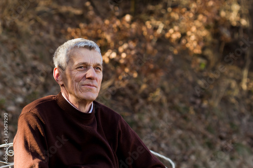 nice elderly white-haired man in a autumn park