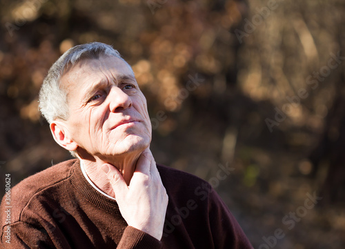 nice elderly white-haired man in a autumn park photo