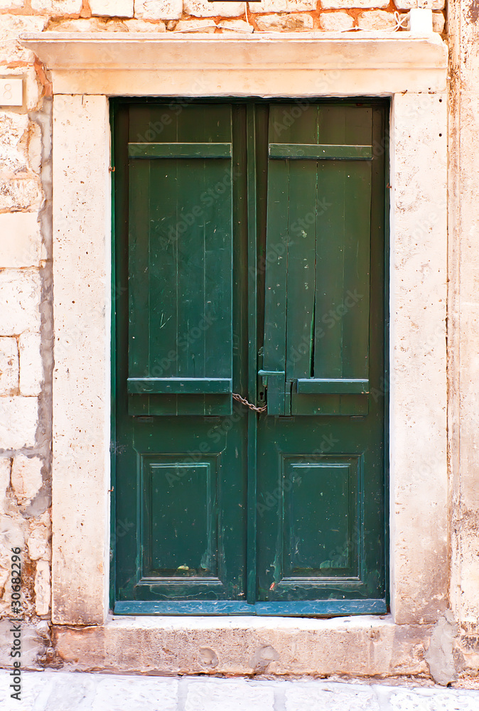Green wooden doors in Dubrovnik, mediterranean town on the coast Green wooden doors in Dubrovnik, mediterranean town on the coast